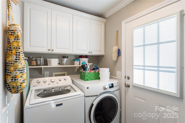 laundry area with cabinets, independent washer and dryer, ornamental molding, and a wealth of natural light