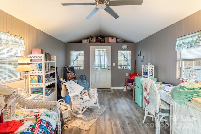 interior space with ceiling fan, plenty of natural light, hardwood / wood-style floors, and vaulted ceiling