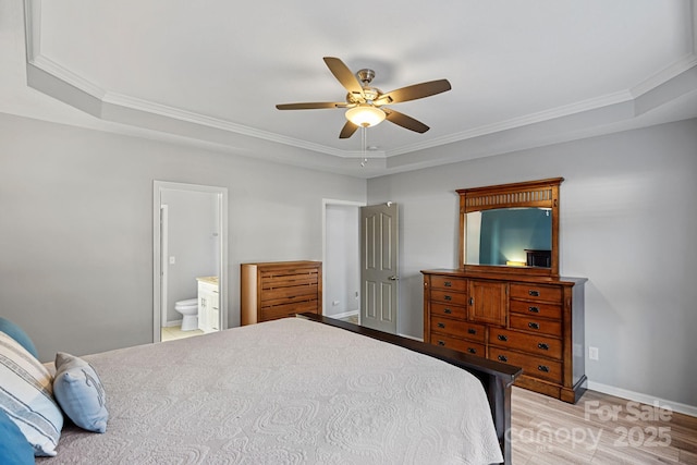 bedroom with ensuite bathroom, a raised ceiling, ceiling fan, and crown molding