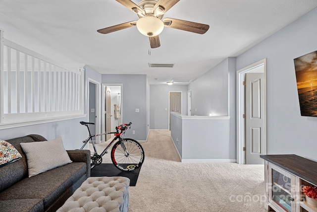 carpeted living room featuring ceiling fan