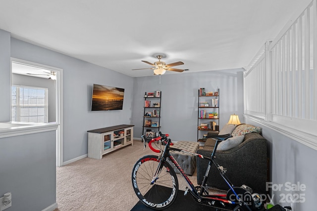 recreation room with ceiling fan and light colored carpet