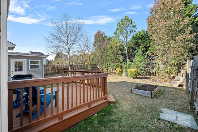 wooden deck featuring a lawn