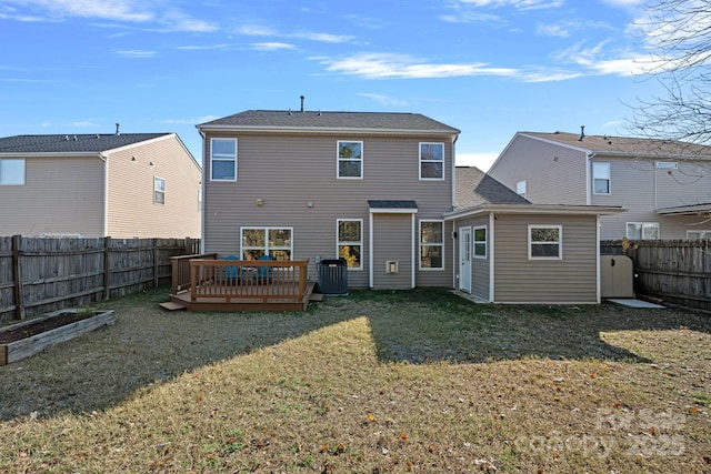 rear view of property with a lawn, cooling unit, and a wooden deck