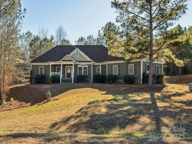 view of front facade with a front lawn and covered porch