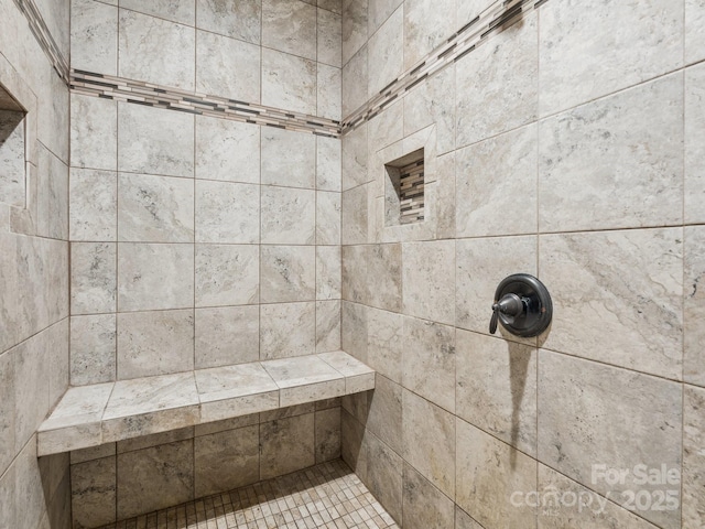 bathroom with a tile shower