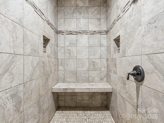 bathroom with tiled shower