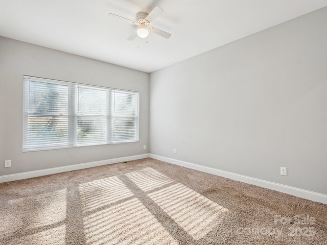 carpeted empty room with ceiling fan