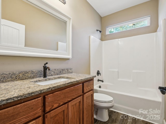 full bathroom with wood-type flooring, vanity, toilet, and shower / bathtub combination