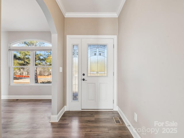 foyer featuring dark hardwood / wood-style flooring and crown molding