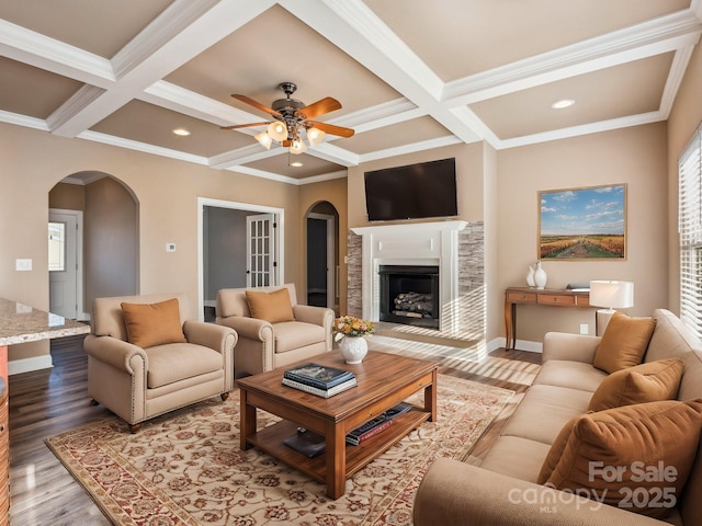 living room with coffered ceiling, ceiling fan, crown molding, beam ceiling, and light hardwood / wood-style floors