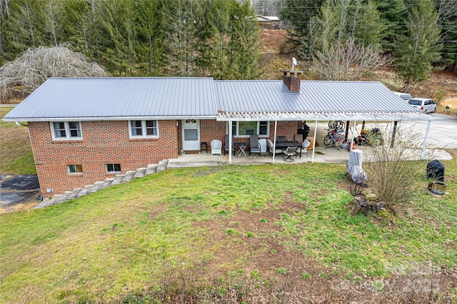 rear view of property with a yard and a patio