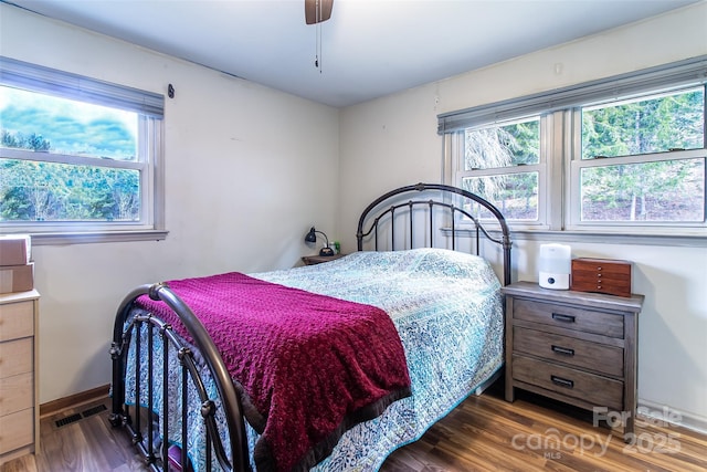 bedroom with ceiling fan and dark hardwood / wood-style flooring