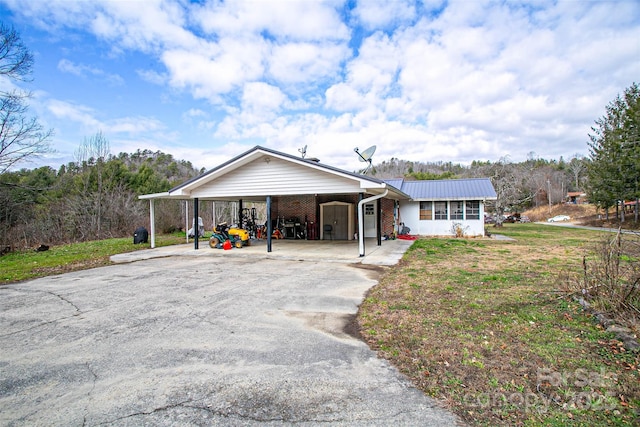 single story home with a front lawn and a carport