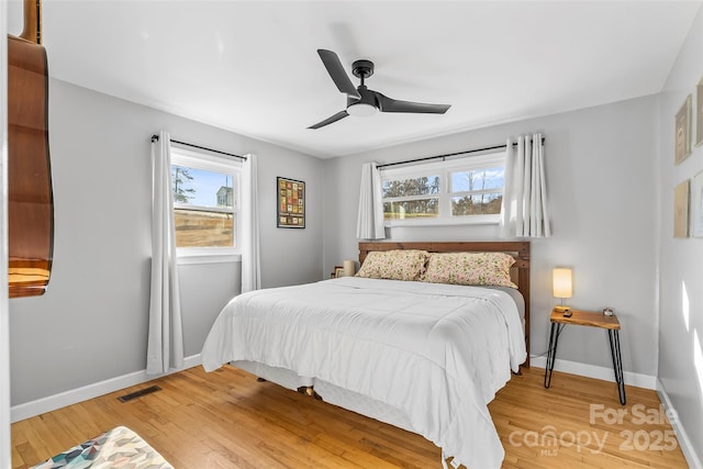 bedroom with ceiling fan and hardwood / wood-style floors