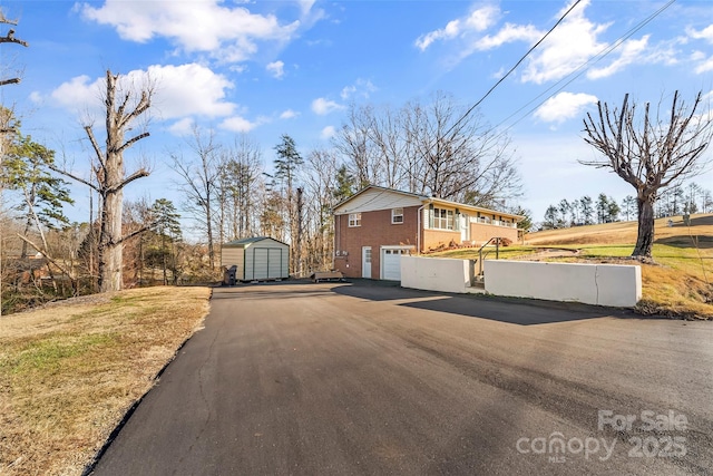 view of side of property featuring a garage and a storage shed