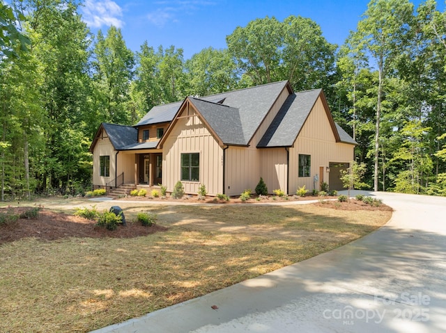 modern farmhouse style home with a front yard and a porch