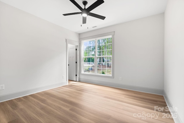 empty room with hardwood / wood-style floors and ceiling fan