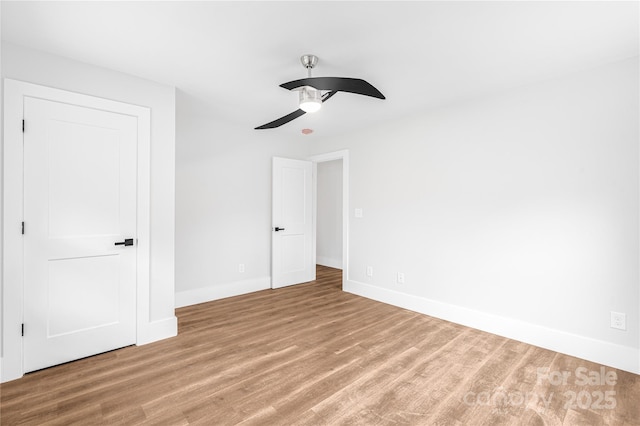 unfurnished bedroom featuring ceiling fan and hardwood / wood-style flooring