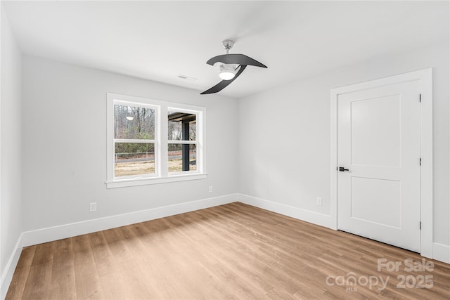 empty room featuring ceiling fan and light hardwood / wood-style floors