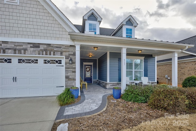 doorway to property featuring covered porch and a garage