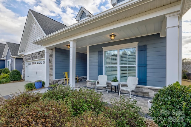 exterior space featuring a porch and a garage