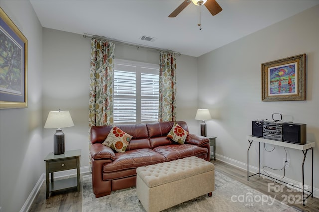 living room with ceiling fan and light hardwood / wood-style flooring