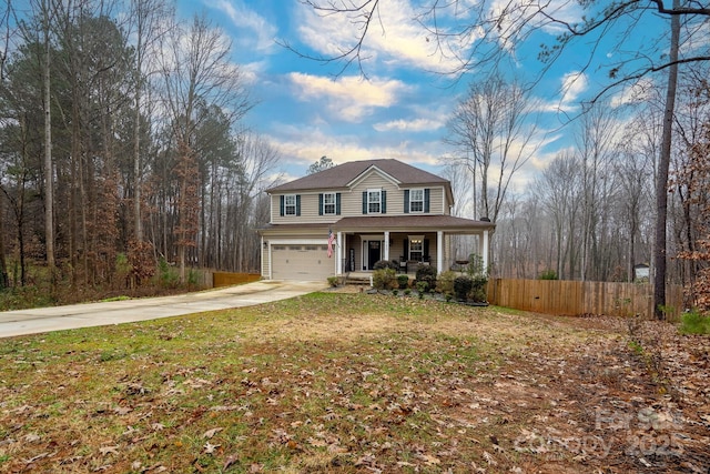 front of property featuring a porch, a garage, and a front lawn