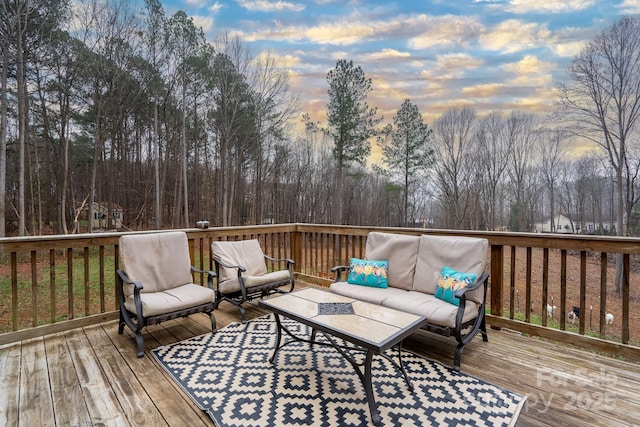 deck at dusk featuring an outdoor living space