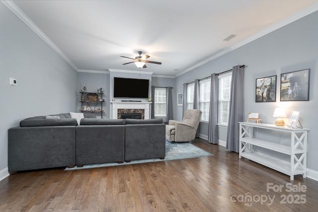 living room featuring hardwood / wood-style floors, ceiling fan, and crown molding