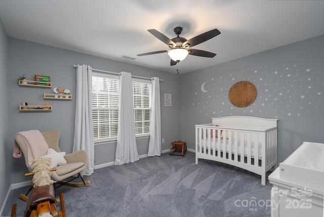 carpeted bedroom with a nursery area and ceiling fan