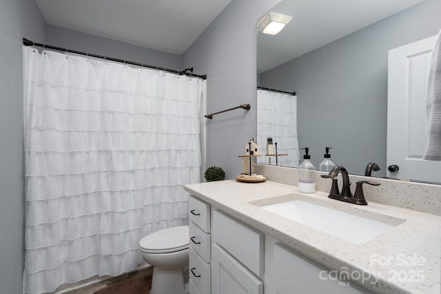 bathroom with hardwood / wood-style floors, vanity, and toilet