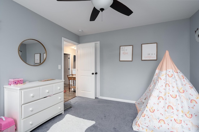 bedroom with ceiling fan and dark carpet