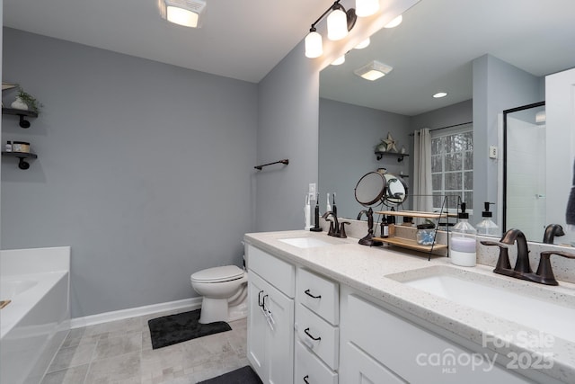 bathroom featuring a bathing tub, vanity, and toilet