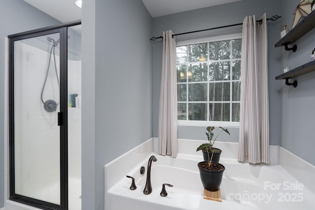 bathroom featuring independent shower and bath