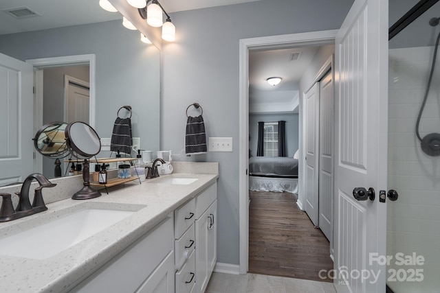 bathroom with vanity and hardwood / wood-style flooring