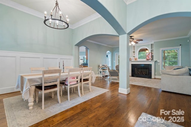 dining room featuring crown molding, dark hardwood / wood-style floors, and ceiling fan with notable chandelier