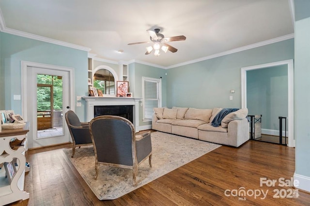 living room featuring crown molding, ceiling fan, and dark wood-type flooring