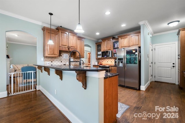 kitchen with decorative light fixtures, stainless steel fridge, kitchen peninsula, and backsplash