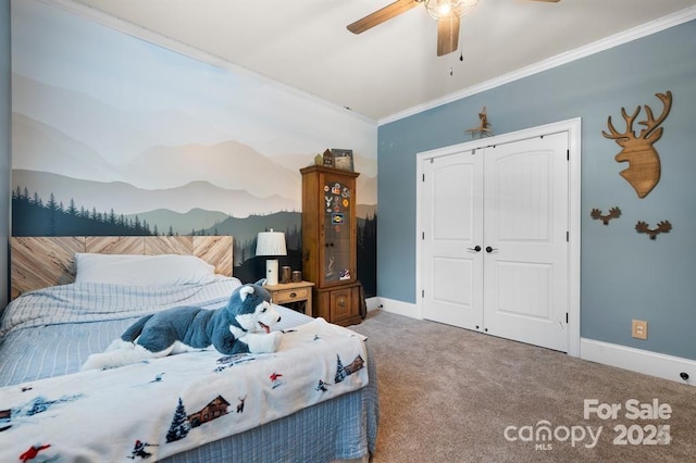 bedroom with carpet, a closet, ceiling fan, and crown molding