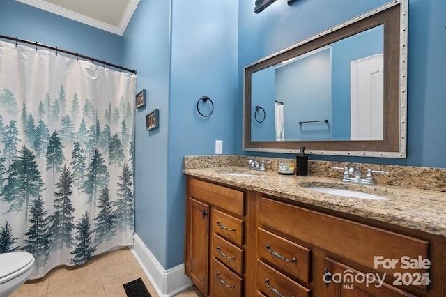 bathroom featuring tile patterned flooring, vanity, toilet, and crown molding