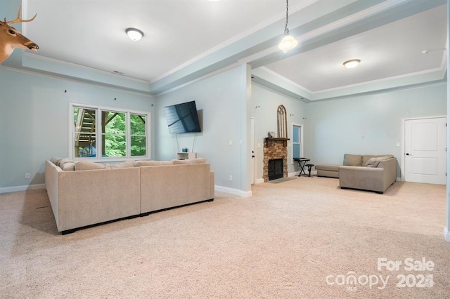 living room with a fireplace, light carpet, a raised ceiling, and crown molding