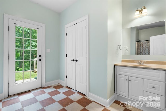 bathroom featuring vanity and curtained shower