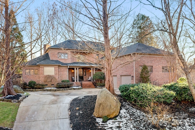 view of front of home featuring covered porch and a garage