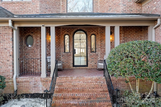 view of exterior entry with a porch