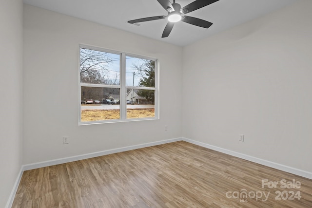 unfurnished room featuring ceiling fan and light wood-type flooring