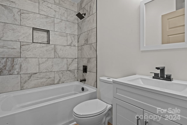 full bathroom featuring vanity, toilet, and tiled shower / bath