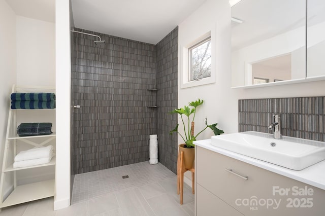 bathroom with vanity, tile patterned floors, and a tile shower