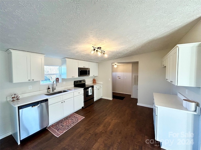 kitchen featuring dark wood-type flooring, sink, a textured ceiling, appliances with stainless steel finishes, and white cabinetry