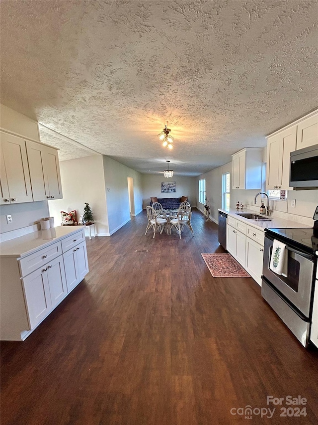 kitchen featuring white cabinets, sink, appliances with stainless steel finishes, and a textured ceiling