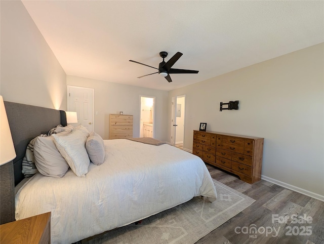 bedroom with ceiling fan, dark hardwood / wood-style flooring, and ensuite bath